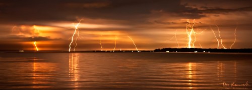 Multiple lightning bolts across water